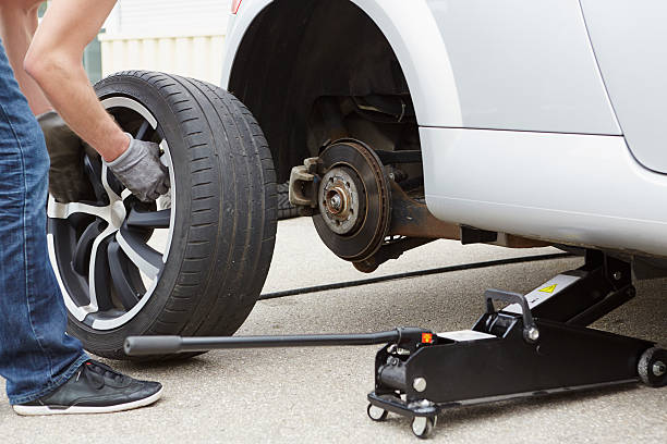 Mechanic changing oil on a car